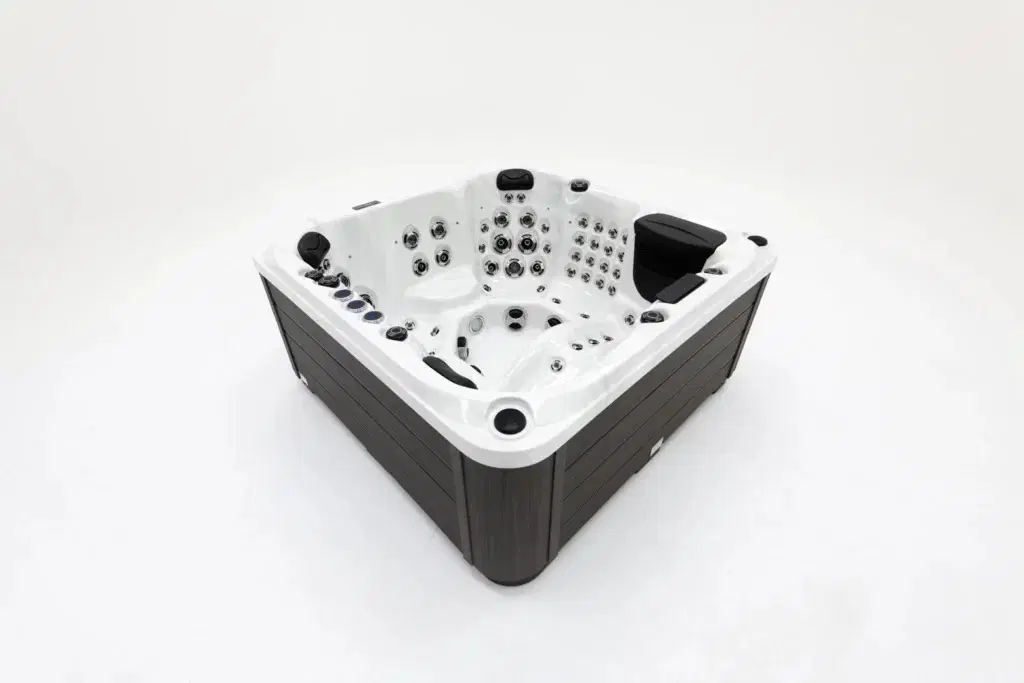 White hot tub with black exterior panels and multiple seating jets, photographed in a white studio background.
