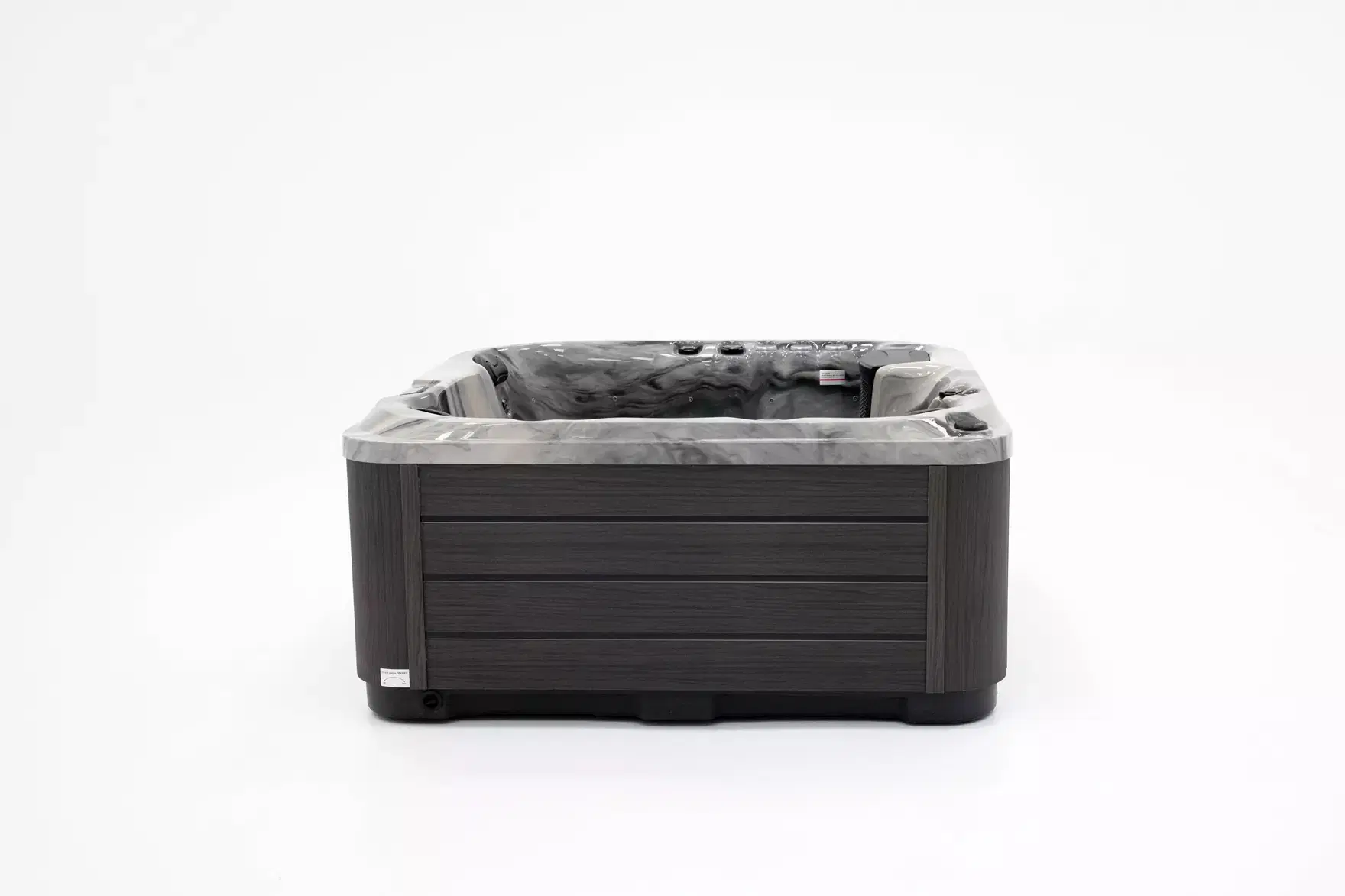 Outdoor hot tub with dark wooden exterior and gray marbled interior, ready for use against a white background.